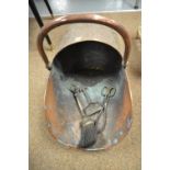 A Victorian copper helmet shaped coal scuttle