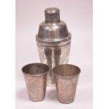 A Persian silver cocktail shaker and two cups