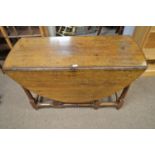 An oak drop leaf dining table