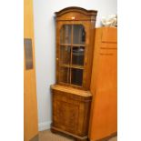 A walnut and burr walnut corner cabinet,