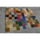 A modern checkerboard carpet woven in colours, 250 x 305cms.