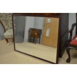 A large rectangular bevelled wall mirror.