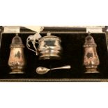 A three piece silver condiment set