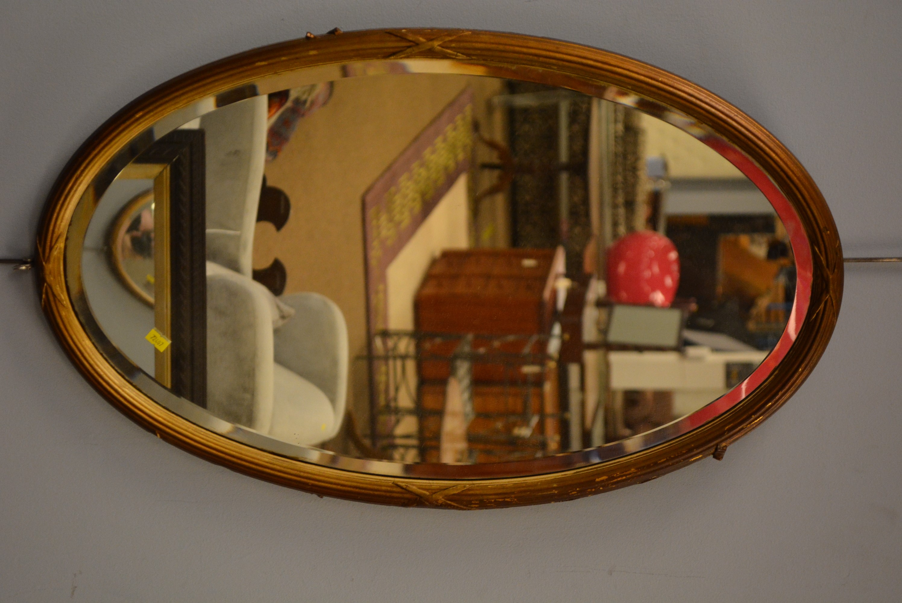 Oval bevelled wall mirror.