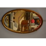 Oval bevelled wall mirror.