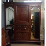 An Edwardian carved mahogany wardrobe and matching dressing table, the wardrobe with gadrooned