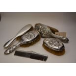 Five silver backed dressing table items