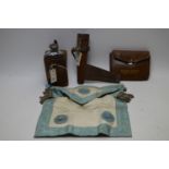 Two hunting flasks; and a Masonic apron, all in leather cases.
