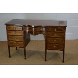 An Edwardian breakfront sideboard.