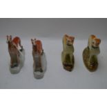 Two pairs of Staffordshire greyhound figures.