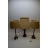 Pair of table lamps; and another table lamp.