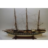Scale wooden model of a three-masted sailing ship.