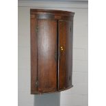 Georgian inlaid bowfront corner cabinet.