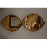 A pair of ornate oval mirrors.