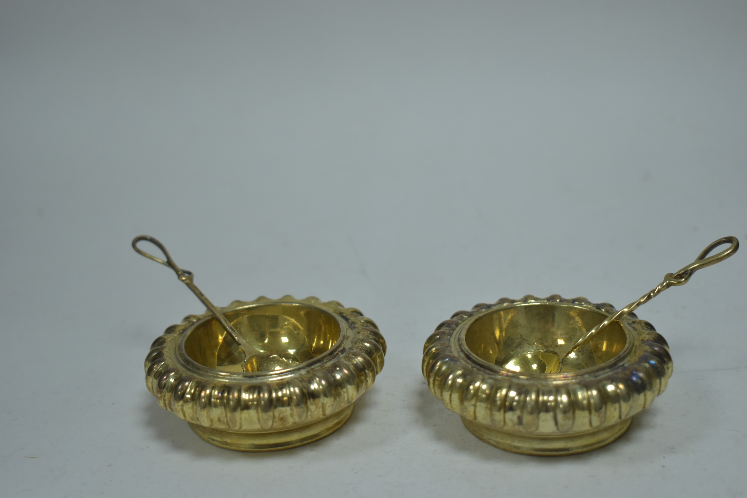 A pair of gilt metal table salts