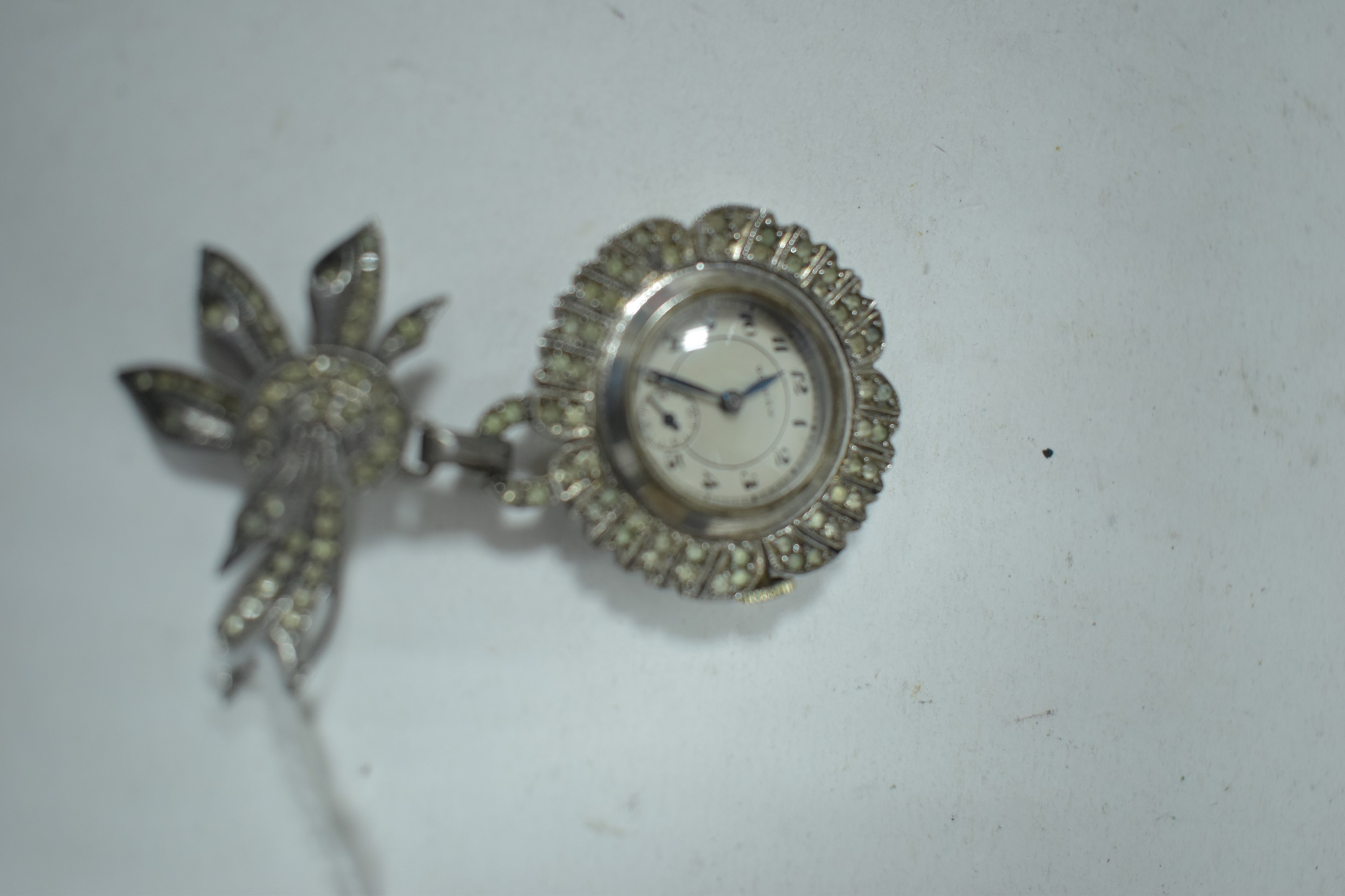 A paste set silver nurses watch by Gotham