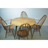 An Ercol dining table and Quaker chairs