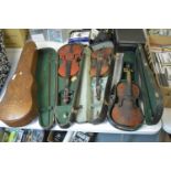 Three cased violins; and a vintage violin case.