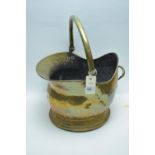 Brass helmet-shaped coal scuttle.