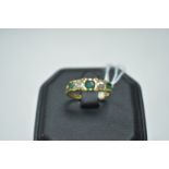 An emerald and diamond ring