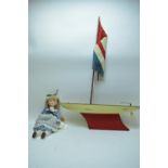 Union Jack pond yacht; and porcelain head doll.