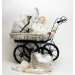 A Victorian-style dolls pram and doll.