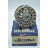 Okuma fishing reel; hiking group medals and badges, 1980's.