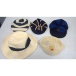 Four sporting caps; and a Panama-style hat.