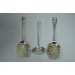 Two silver berry spoons and a sugar casting spoon