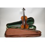A vintage violin and bow, in a crocodile leather case.