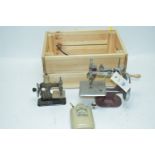Two miniature sewing machines; and a muff warmer.