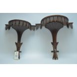 Two carved wood wall brackets.