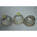 Three silver shell pattern dishes