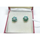 An emerald and diamond cluster earrings