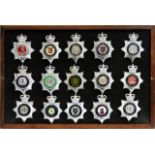 A collection of 20th Century Police badges, framed.