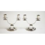 A pair of silver twin branch candelabra