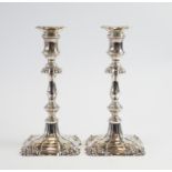 A pair of Georgian style candlesticks