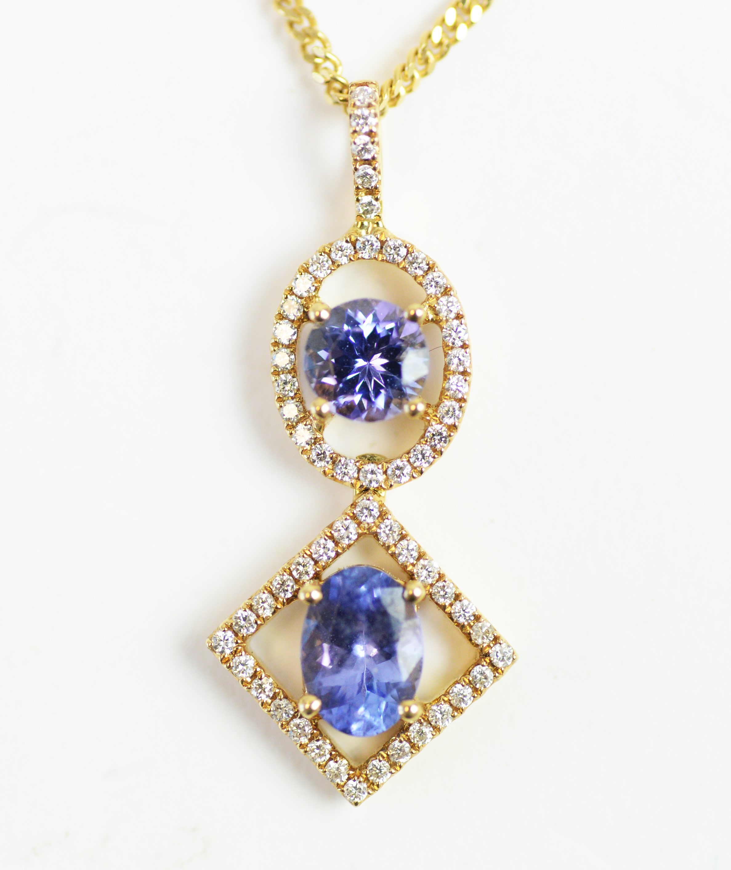 A tanzanite and diamond drop pendant