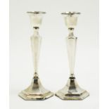 A pair of George V silver candlesticks, by James Deakin & Sons