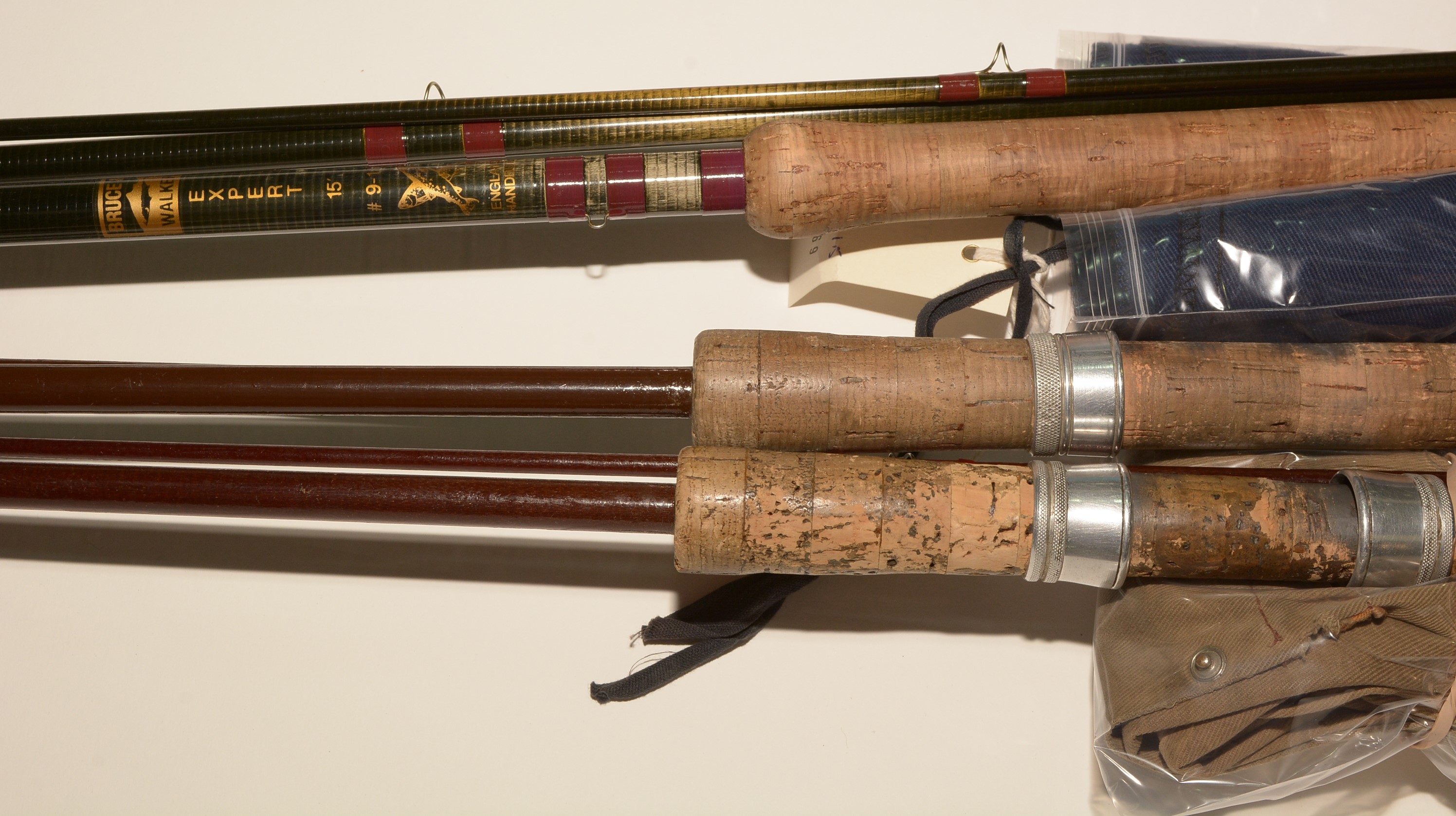 An Expert fishing rod; and two fibreglass rods.