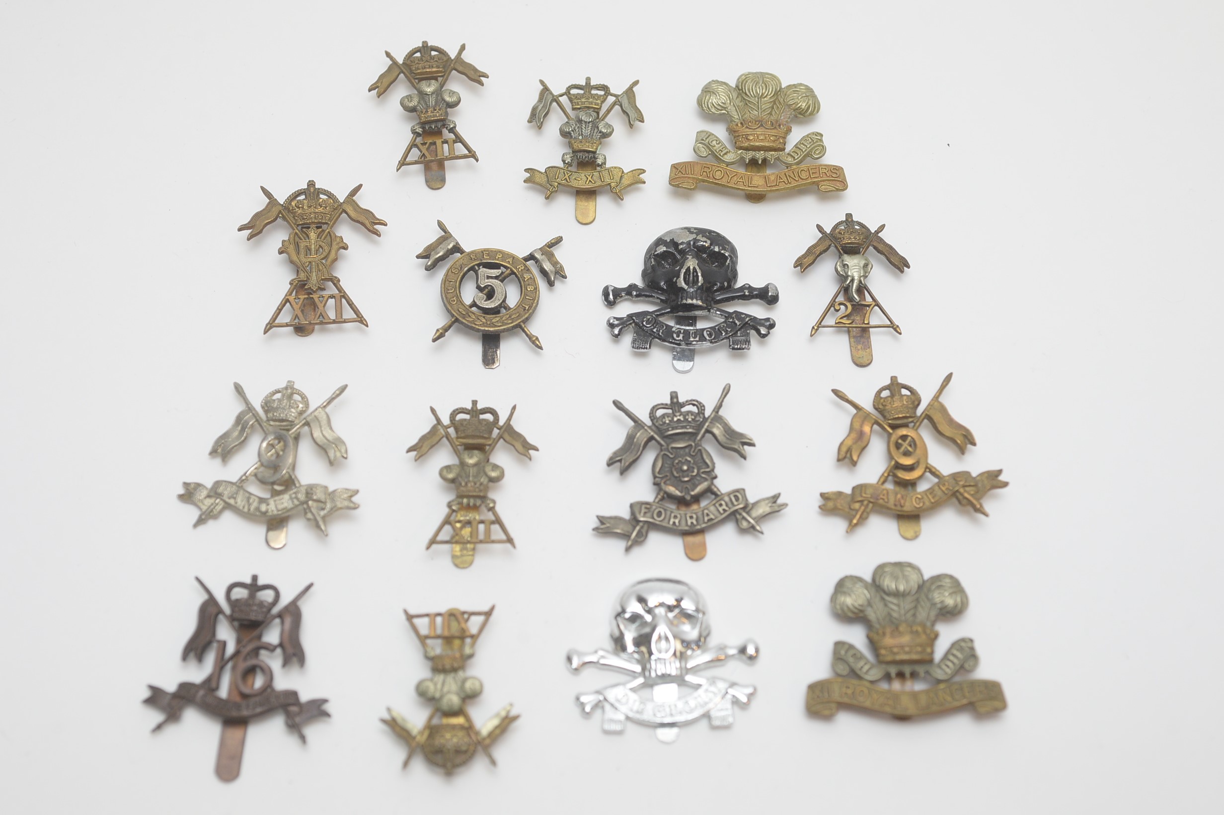 A collection of Lancers regimental cap badges