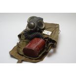 A WWII 1940s gas mask with original carry bag