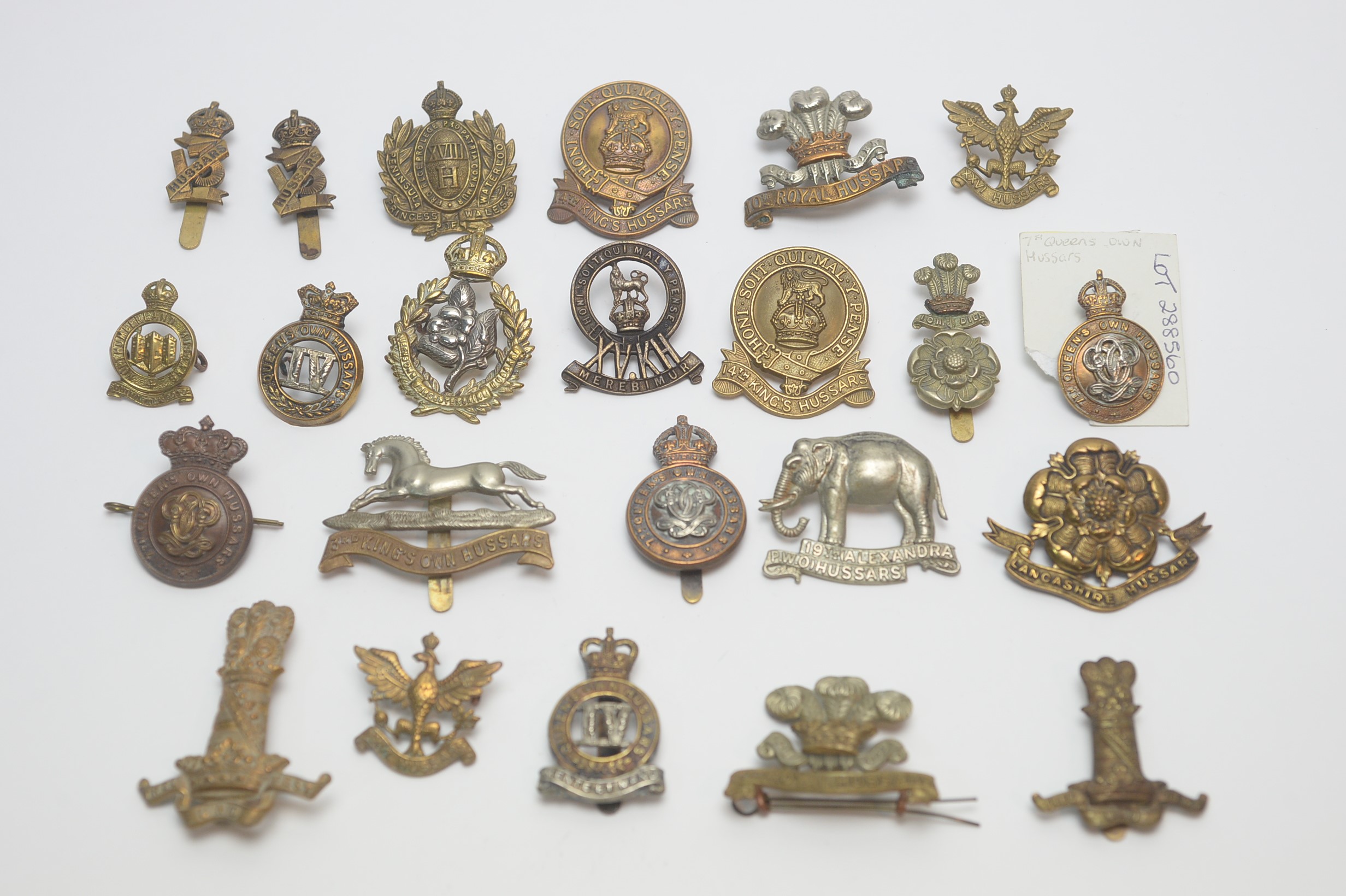 A collection of Hussars regimental cap badges