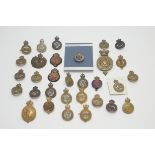 A collection of regimental cap badges