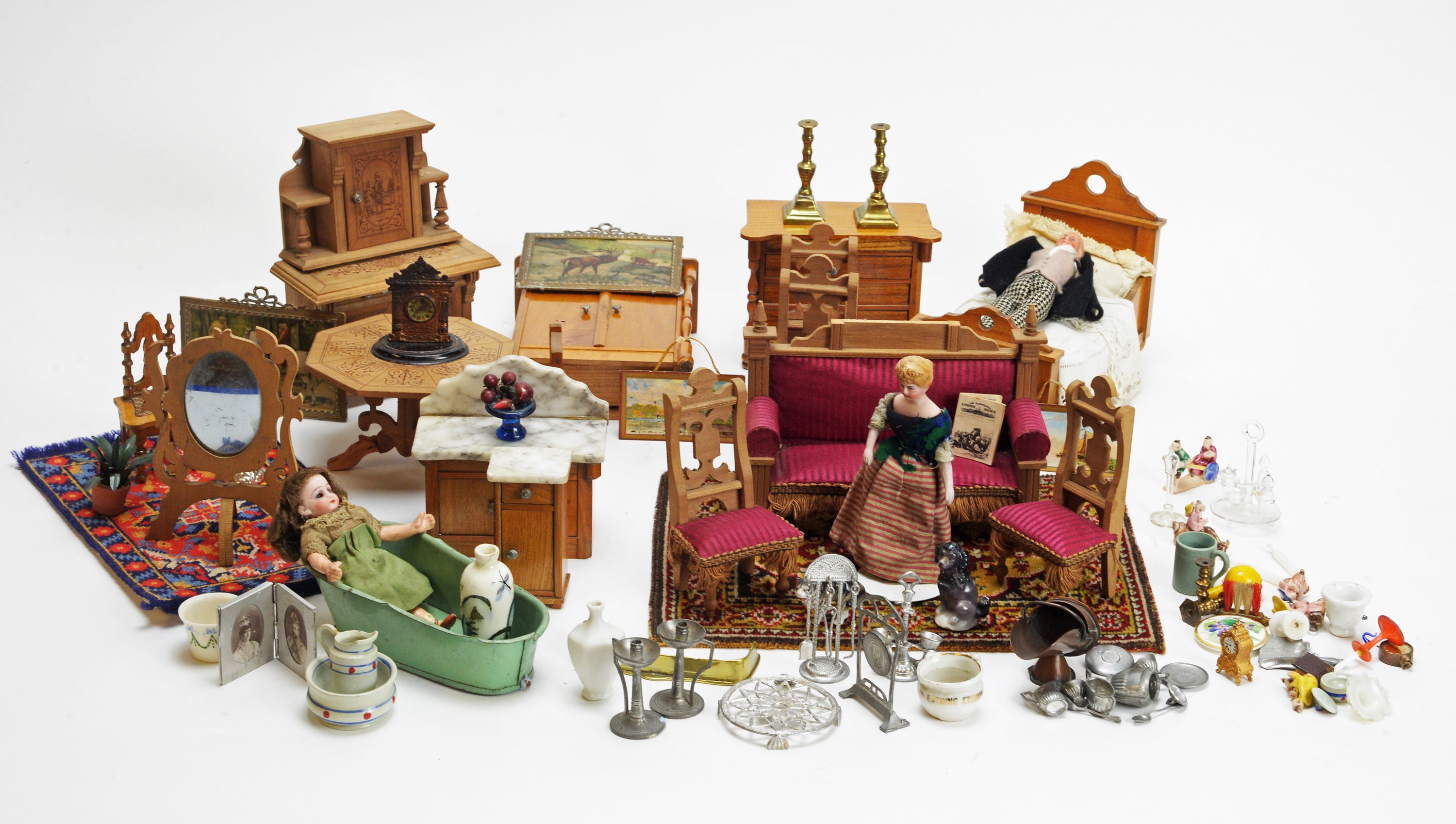 A collection of doll's house dolls, furniture and other items.