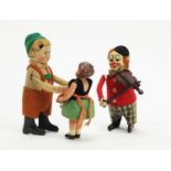 Schuco, Germany: a clockwork boy and baby sister automaton toy; and a clown violinist.