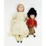 A late 19th Century English bisque head doll; and a German bisque head doll.