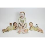 A pair of bisque piano baby dolls, and two others.