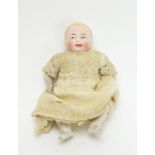 A 19th Century bisque miniature baby doll.