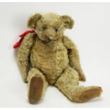An early plush teddy bear, probably Steiff.